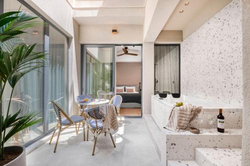 a room with a balcony with a table and chairs at Dock 38 Apartments Collection in Piraeus