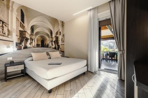 a bedroom with a white bed and a large window at 4 Rent di Cicchinelli Lorella in Albano Laziale