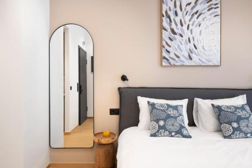 a bedroom with a large mirror and a bed at Dock 38 Apartments Collection in Piraeus