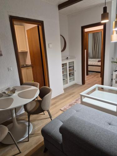 a living room with a bed and a table and chairs at Nuvola in Ravascletto