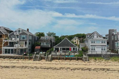 a group of houses sitting on the beach at Beachfront on Commercial St Dog Friendly in Provincetown