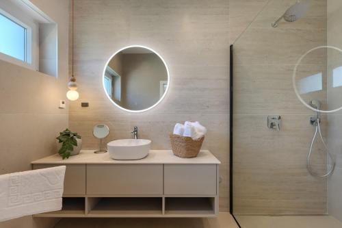 a bathroom with a sink and a mirror at Villa Dell Arte in Žminj