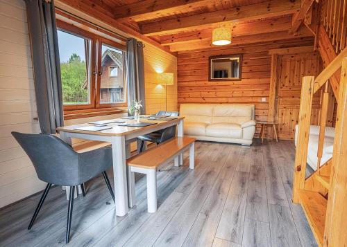 a dining room with a table and chairs in a cabin at Benview Holiday Lodges in Gartmore