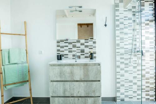 a bathroom with a concrete sink and a mirror at Villa La Era 2 in El Cotillo