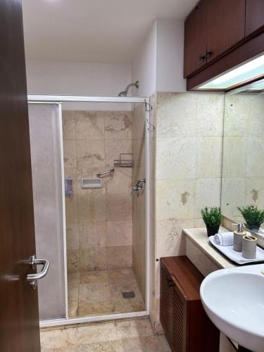 a bathroom with a shower and a sink at Apartment 3BR Prima Bragacitywalk in Bandung