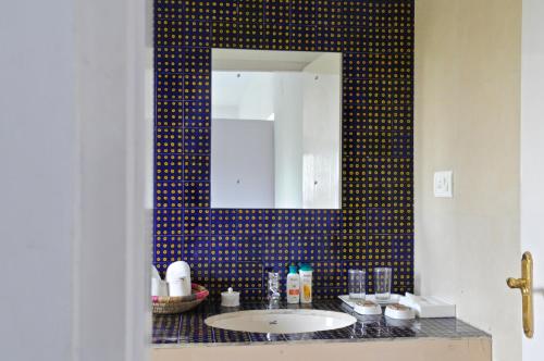 a bathroom with a sink and a mirror at Savista Retreat in Jaipur