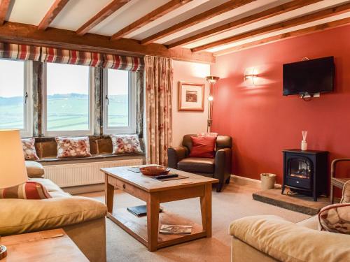 a living room with a couch and a table at Mount View - Uk48425 in Holmfirth