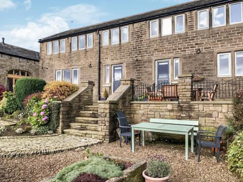 a brick building with a table in front of it at Mount View - Uk48425 in Holmfirth