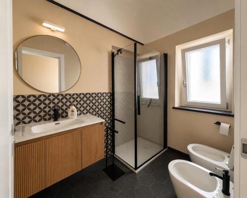 a bathroom with a shower and a sink and a mirror at Cà di Righe in Pietra Ligure