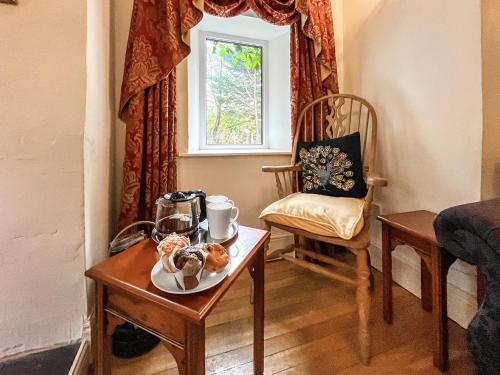 a room with a table and a chair at Y Ddol in Llansannan