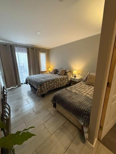 a hotel room with two beds and a window at Punta Luna in La Serena