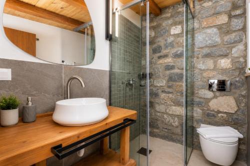 a bathroom with a sink and a shower at La Casa Di Pietre 3 in Kiotari