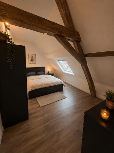 a bedroom with a bed in a attic at Les lodges d'Eva de Chièvres in Chièvres