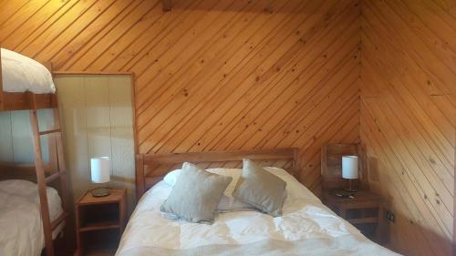 a bedroom with a bed with a wooden ceiling at MI Lodge Las Trancas Hotel & Spa in Las Trancas