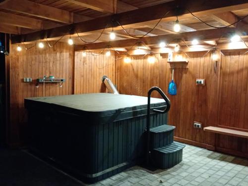a large bath tub in a room with lights at Gawędówka in Czchów