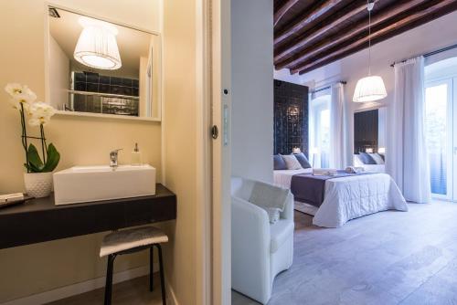 a bathroom with a sink and a toilet at LuxurYenne B&B in Cagliari