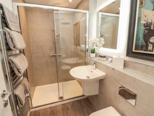 a bathroom with a shower and a sink at Hidden Gem in Windermere