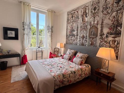 a bedroom with a bed and a large window at La maison au cèdre in Marsac-sur-lʼIsle
