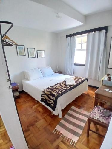 a bedroom with a bed and a window at Mezanino 131 in Ouro Preto