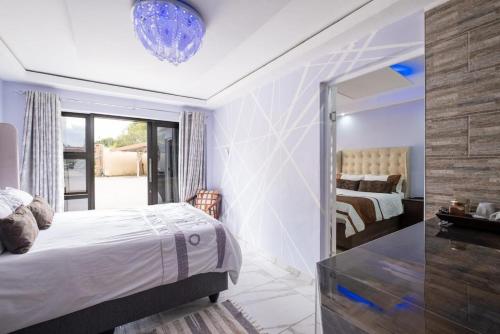 a bedroom with a bed and a mirror at Siyajabula Guesthouse in Howick