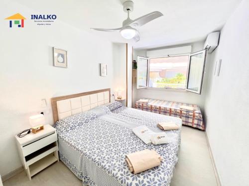 a bedroom with a bed and a window at Cala Montero - Inalko in Alcossebre