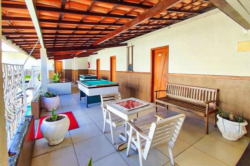 a patio with a table and a pool table at Happy Hotel Ancoradouro in Porto Seguro