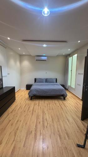 a bedroom with a bed and a blue light on the ceiling at سفانه in Unayzah