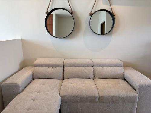 a living room with a couch and two mirrors at San Francisco Cancun in Cancún
