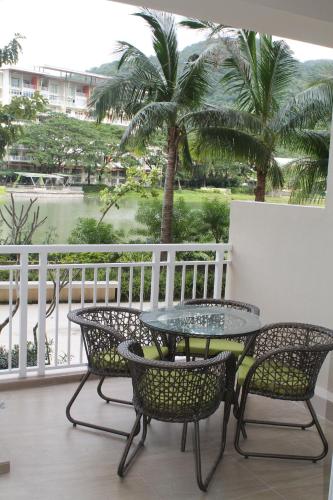 a patio with a table and chairs on a balcony at CAROLA in Pico de Loro in Nasugbu