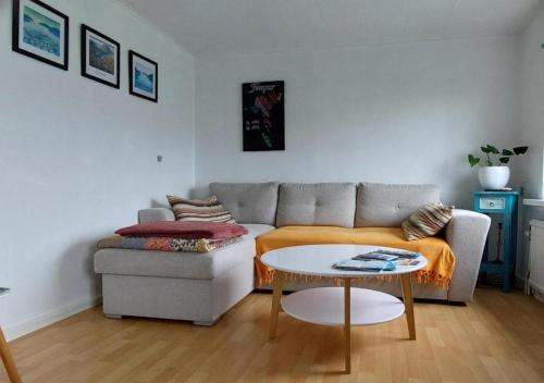 a living room with a couch and a table at Cozy apartment in Klaksvík