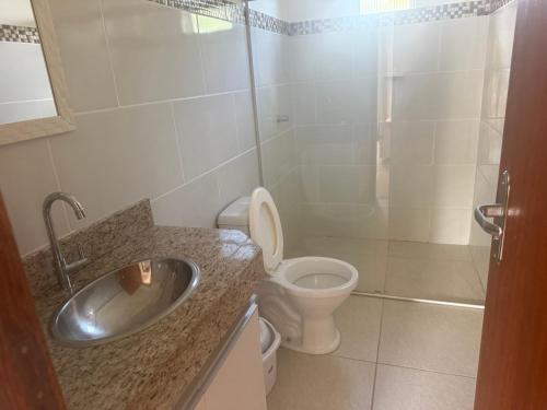 a bathroom with a sink and a toilet at Red Coral Apts in Coroa Vermelha