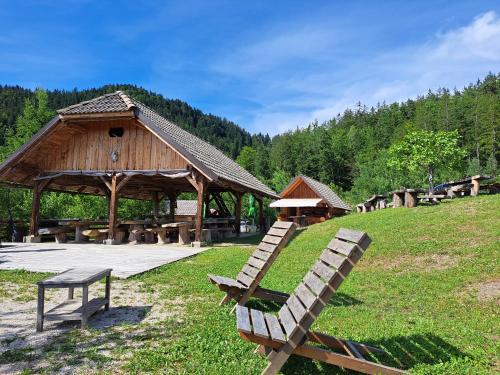 a park with a pavilion and benches in the grass at Glamping Gril in Ljubno