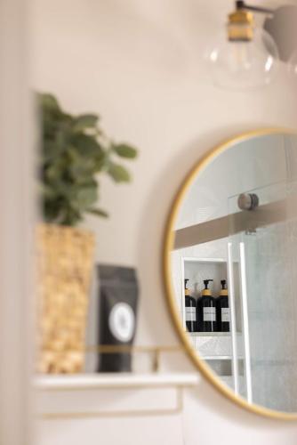 a mirror on a wall in a bathroom at Poolside Palms - Team Joseph Ellen in Jacksonville Beach
