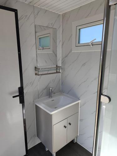 a white bathroom with a sink and a mirror at Deer Meadow #1 in Maynooth