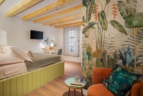 a hotel room with a bed and a wall mural at Palazzo Viridis Heritage Hotel in Milna