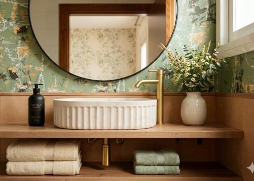 a bathroom with a sink and a mirror and towels at Marbella Views in Ojén