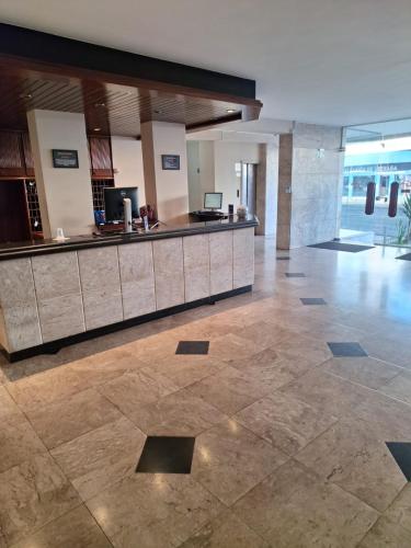 an empty lobby with a counter in a building at Grande Hotel Havana - Hospedagem Econômica in Uberaba