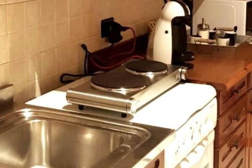 a kitchen counter with a pan on top of a sink at Ca di Biella, mansarda di charme. in Biella