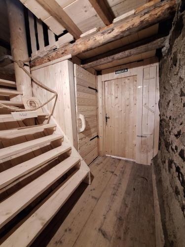 a room with a staircase and a wooden door at Casa Piazzo Due in Brusio