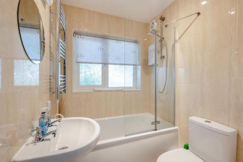 a bathroom with a sink and a shower and a toilet at 2 Bed in Brixham oc-bx081 in Brixham