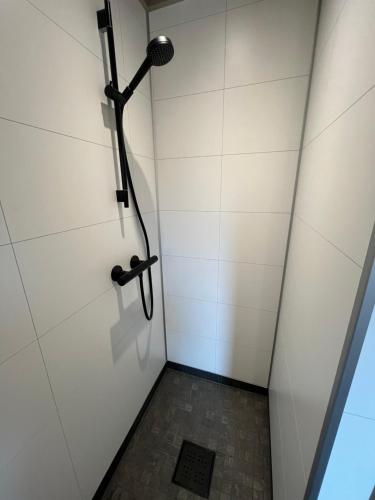 a shower stall with a microphone on the wall at Lofoten Arctic Cabin in Sørvågen