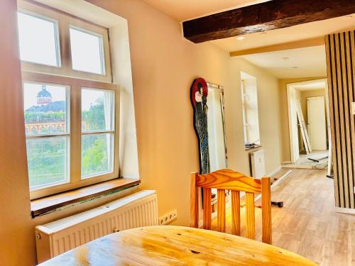 a dining room with a table and a window at Apartment Weilburg Lahnblick in Weilburg