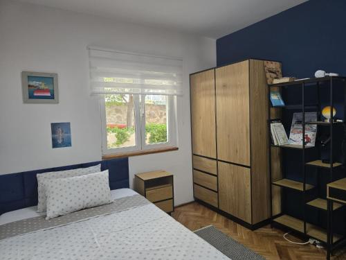 a bedroom with a bed and a wooden cabinet at Villa Joy- Paradise near Split by Istra Vacation in Kučine