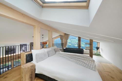 a bedroom with a bed and large windows at Chalet Bucher in Rifiano