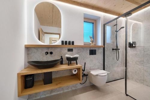 a bathroom with a sink and a mirror at Chalet Bucher in Rifiano