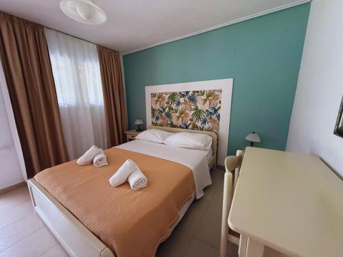 a hotel room with two beds with towels on them at Chrissa Camping Rooms & Bungalows in Delphi