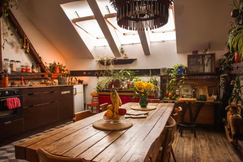 a kitchen with a wooden table with plants on it at Das Nest Budapest in Budapest