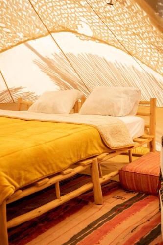 a bedroom with a bed in a tent at Omi Farm & Lodge in Marrakesh