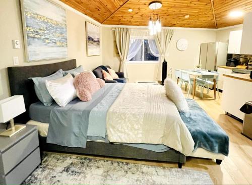 a bedroom with a large bed with pillows on it at Separate guest suite in Lower Sackville