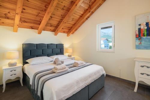 a bedroom with a large bed with towels on it at Holiday Home Nevera in Kaštela